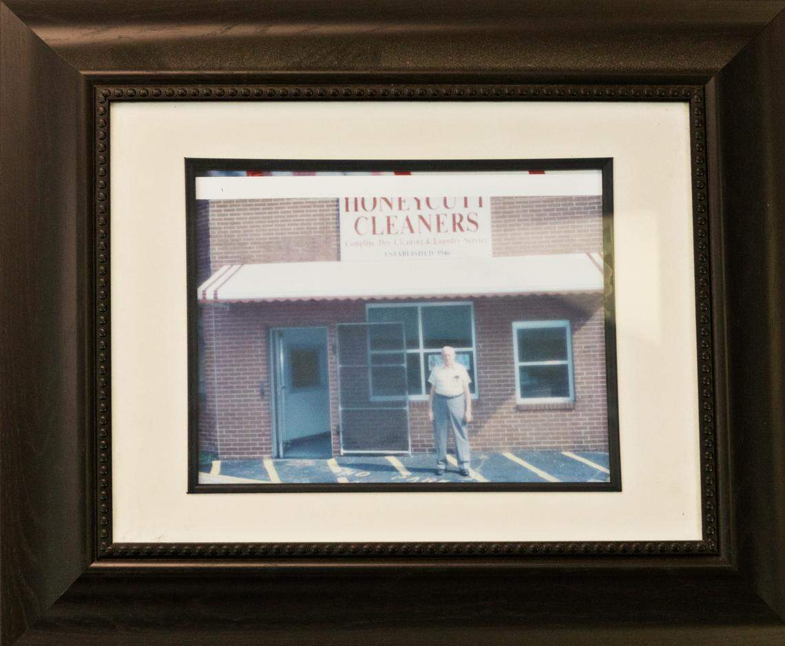 Tim Honeycutt has a photo of his father, Jack, hanging in the Raleigh family business, Honeycutt Cleaners, on Wednesday, May 5, 2021. The business got its start around 1946 and will be closing for good May 14th due to challenges from the pandemic, increases in costs and a drop in business.