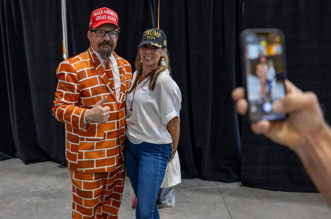 Miranda Tharrington of Franklin County, has her photo taken with “Brick Man”, Blake Marnell of San Diego, Ca. following a rally for Republican presidential nominee, former President Donald Trump on October 30, 2024 in Rocky Mount, N.C.