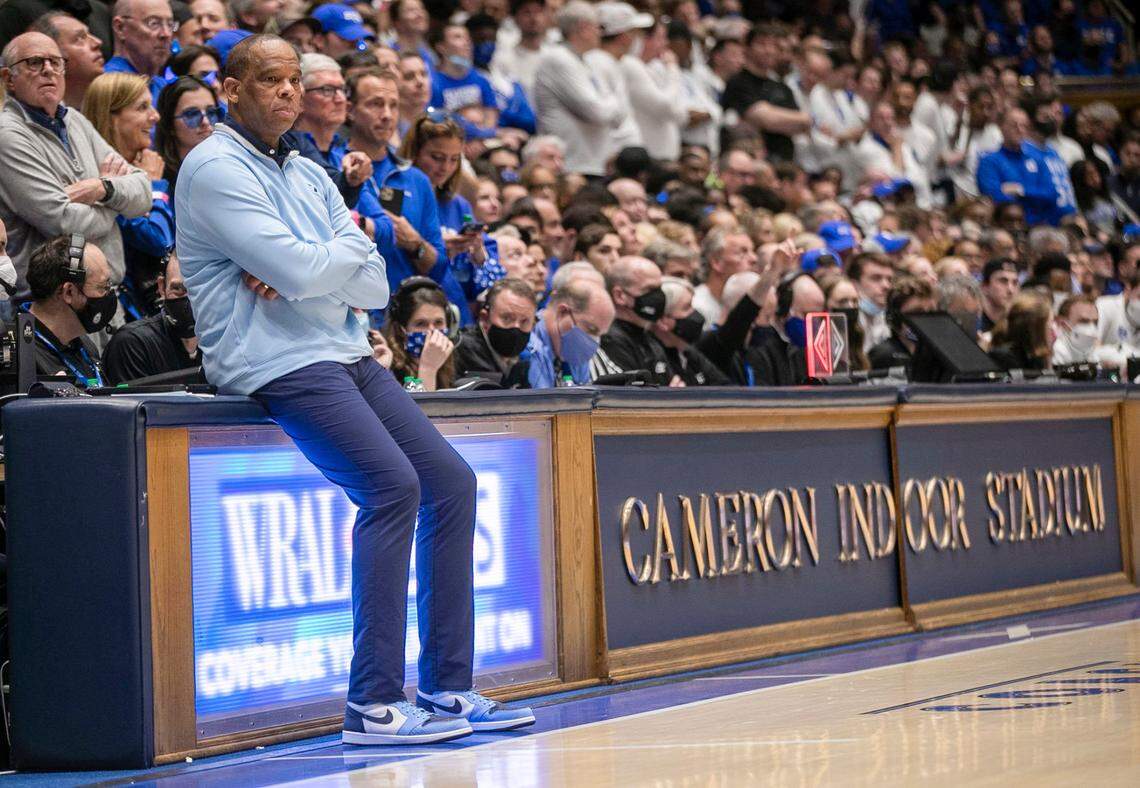 North Carolina coach Hubert Davis takes a seat on the scorers table at Cameron Indoor Stadium as he waits for play to resume following a time-out on Saturday, March 5, 2022 in Durham, N.C.