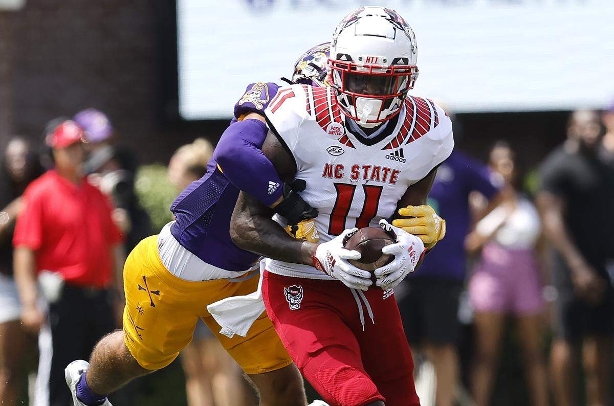 N.C. State wide receiver Darryl Jones (11) pulls in the reception as East Carolina safety Teagan Wilk (9) defends during the first half of N.C. State’s game against ECU at Dowdy-Ficklen Stadium in Greenville, N.C., Saturday, Sept. 3, 2022.
