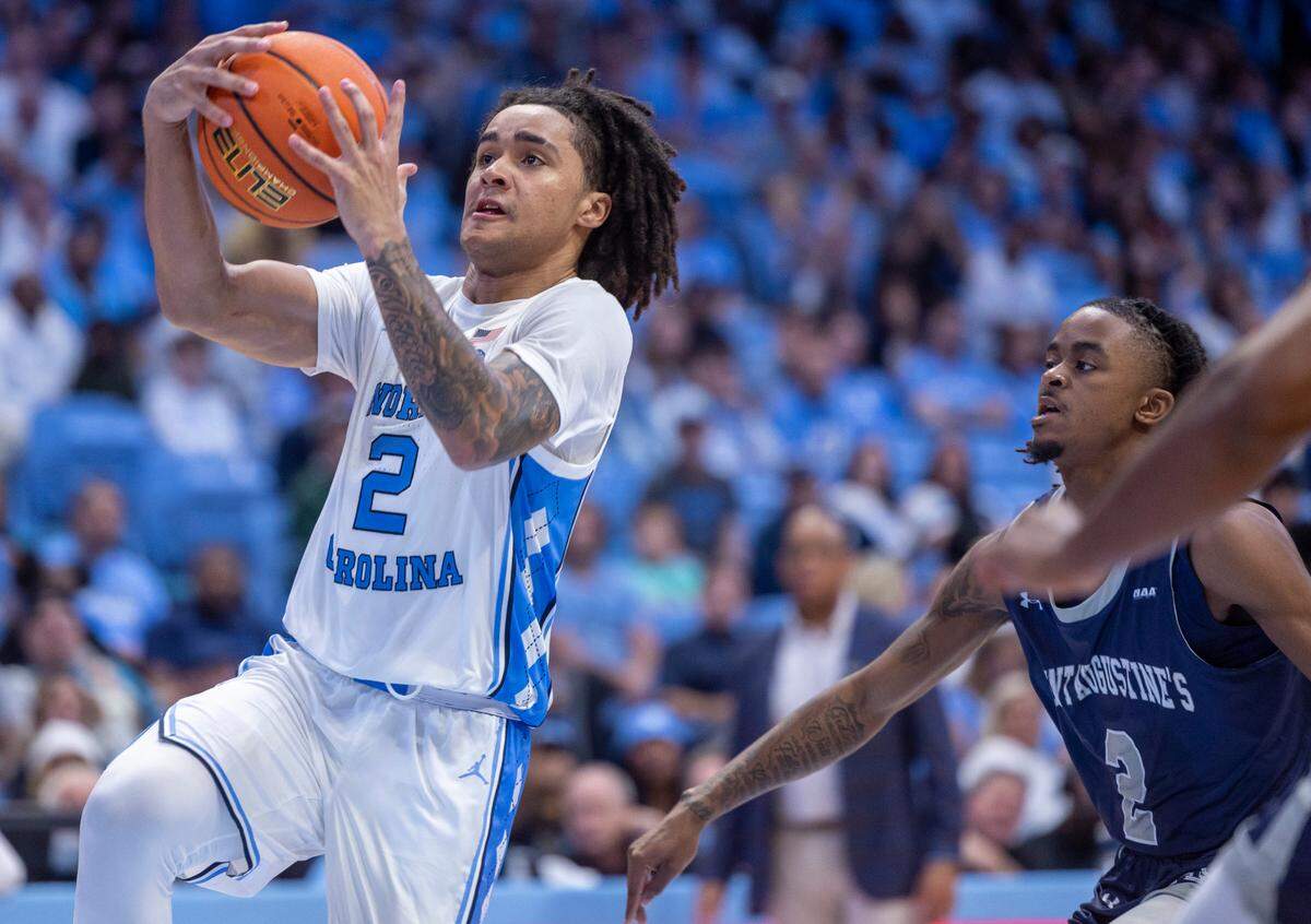 North Carolina’s Elliott Cadeau (2) breaks to the basket ahead of St. Augustine’s Joshua Johnson (2) in the second half on Friday, October 27, 2023 at the Smith Center in Chapel Hill, N.C.