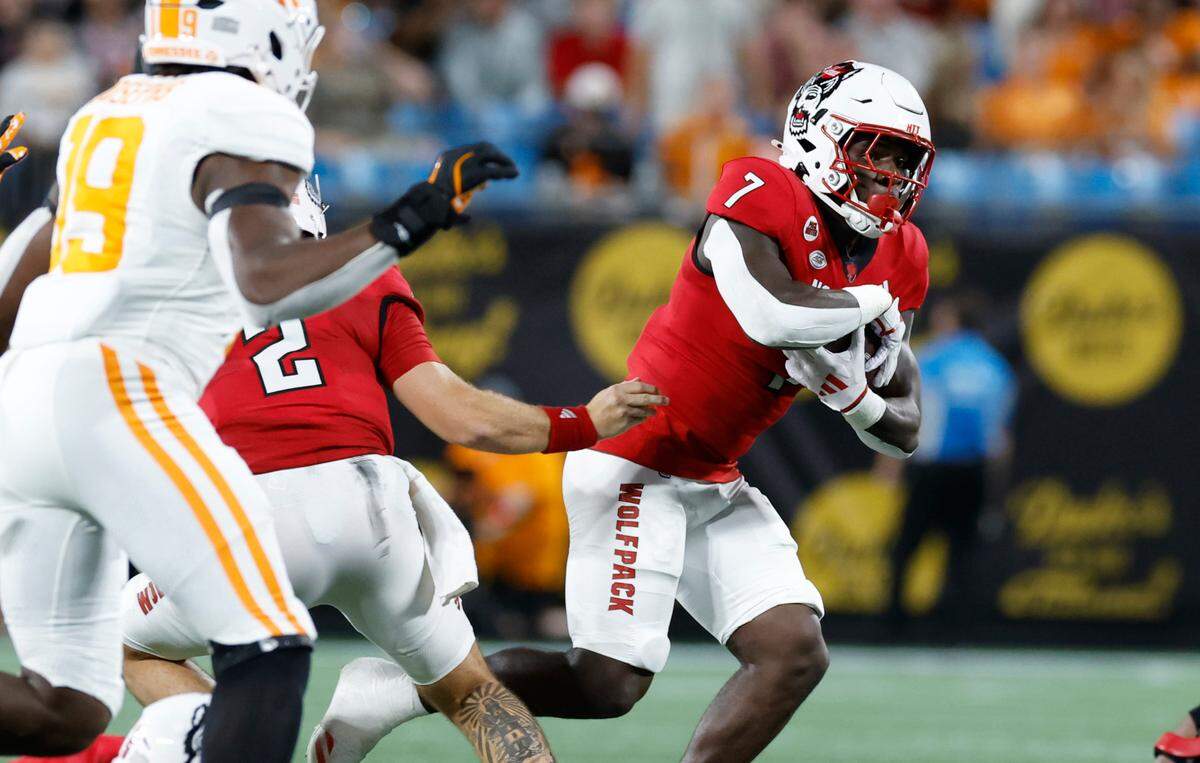 N.C. State running back Jordan Waters (7) looks for an opening during the first half of N.C. State’s game against Tennessee in the Duke’s Mayo Classic at Bank of America Stadium in Charlotte, N.C., Saturday, Sept. 7, 2024.