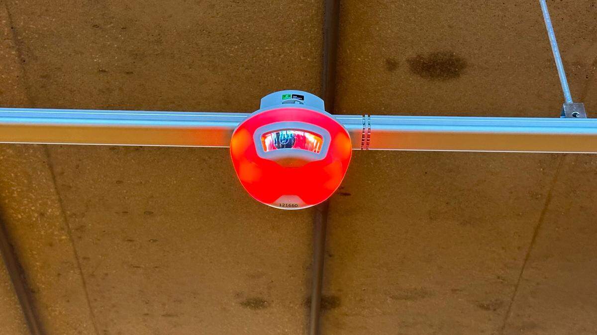 The Park Assist system being tested at Raleigh-Durham International Airport uses cameras embedded in lights to detect when spots are available in the parking deck. A light turns red when nearby spaces are full, green when one is available.