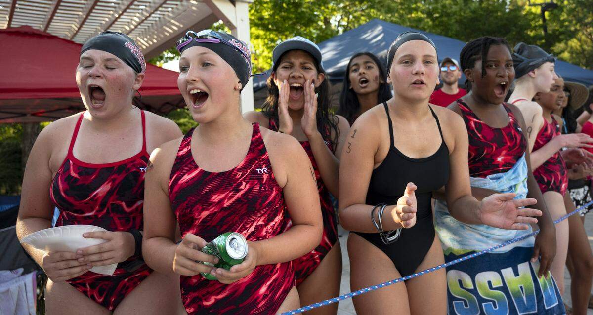 The sea dragon swim team cheers on their swimmers at Cary Park Swim Club during the meet against Scottish Hills Sea Lions on June 25, 2024.