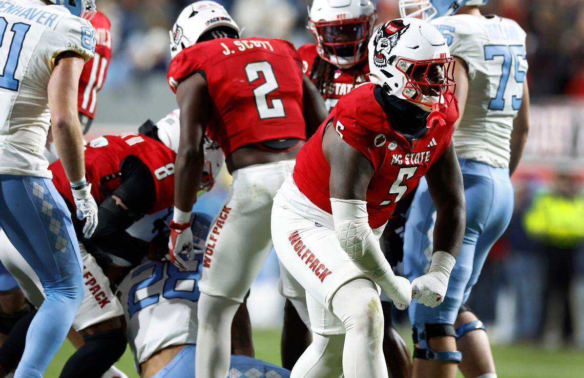 N.C. State defensive tackle C.J. Clark (5) celebrates after stopping North Carolina running back Omarion Hampton (28) during the first half of N.C. State’s game against UNC at Carter-Finley Stadium in Raleigh, N.C., Saturday, Nov. 25, 2023.