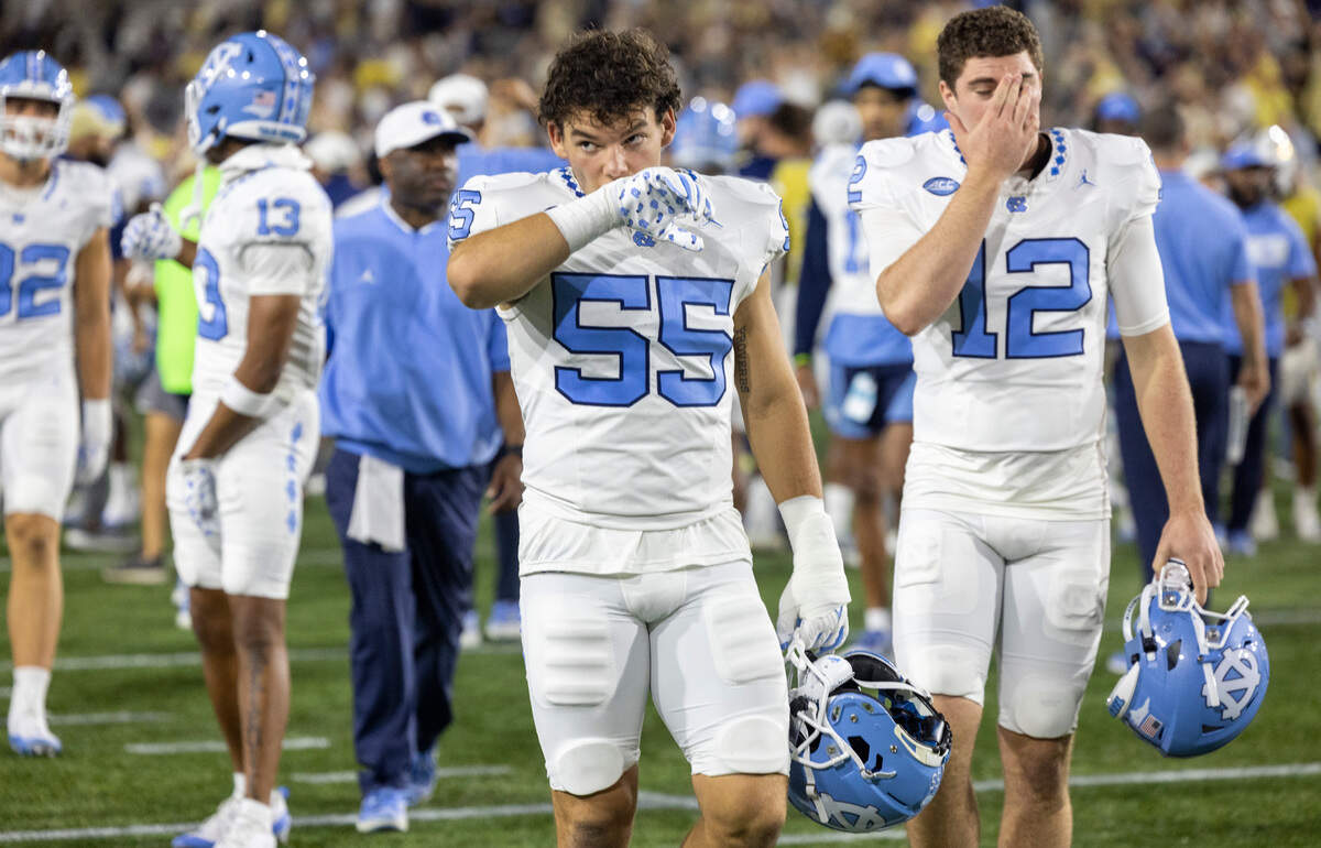North Carolina’s Cade Law (55) and Tad Hudson (12) leave the field following the Tar Heels’ 46-42 loss to Georgia Tech on Saturday, October 28, 2023 at Bobby Dodd Stadium in Atlanta, Georgia.