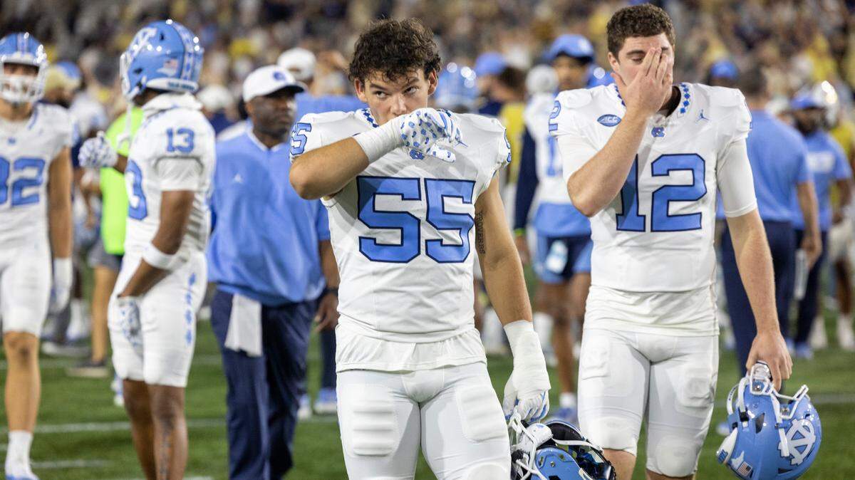 North Carolina’s Cade Law (55) and Tad Hudson (12) leave the field following the Tar Heels’ 46-42 loss to Georgia Tech on Saturday, October 28, 2023 at Bobby Dodd Stadium in Atlanta, Georgia.
