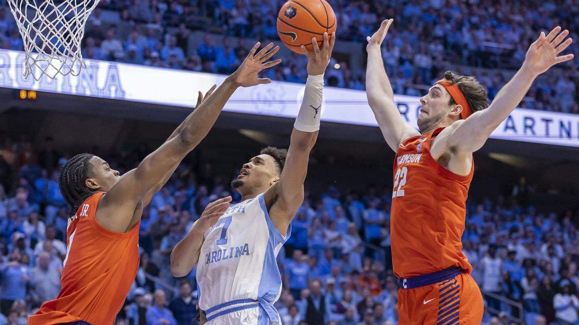 North Carolina guard Seth Trimble (7) drives to the basket between Clemson forward R J Godfrey (0) and forward Carter Welling (22) in the second half on Tuesday, March 3, 2026 at the Smith Center in Chapel Hill, N.C.