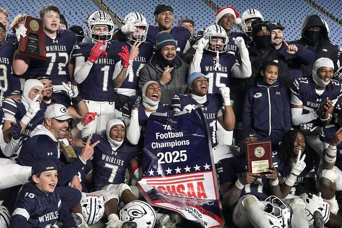 The Greensboro Grimsley Whirlies celebrate with their Championship trophies and banner after victory over Clayton in the NCHSAA 7A Football Championship Game.  The Clayton Comets and the Grimsley Whirlies met in the NCHSAA 7A football Championships in Chapel Hill, NC on December 12, 2025.
