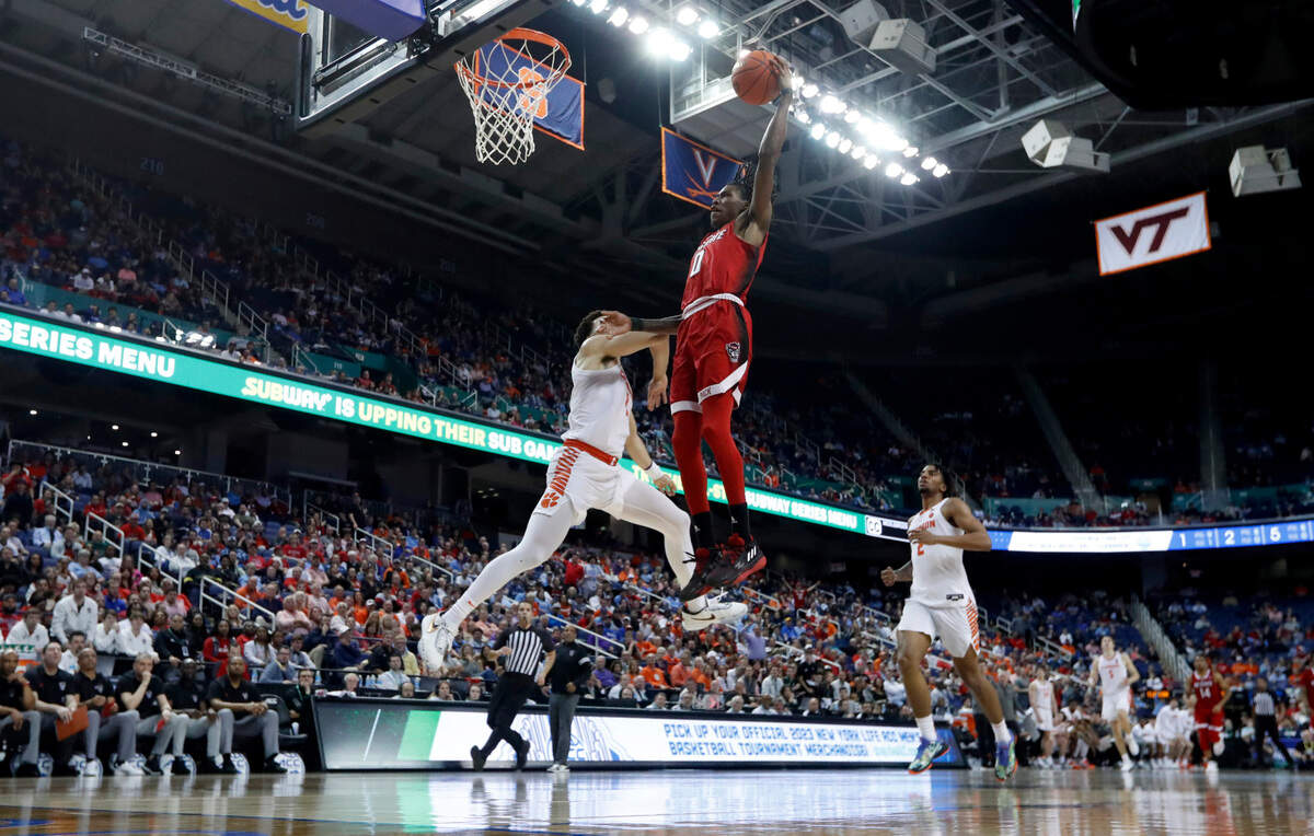 N.C. State’s Terquavion Smith (0) heads to slam in two as Clemson’s Chase Hunter (1) defends during Clemson’s 80-54 victory over N.C. State in the quarterfinals of the ACC Men’s Basketball Tournament in Greensboro, N.C., Thursday, March 9, 2023.