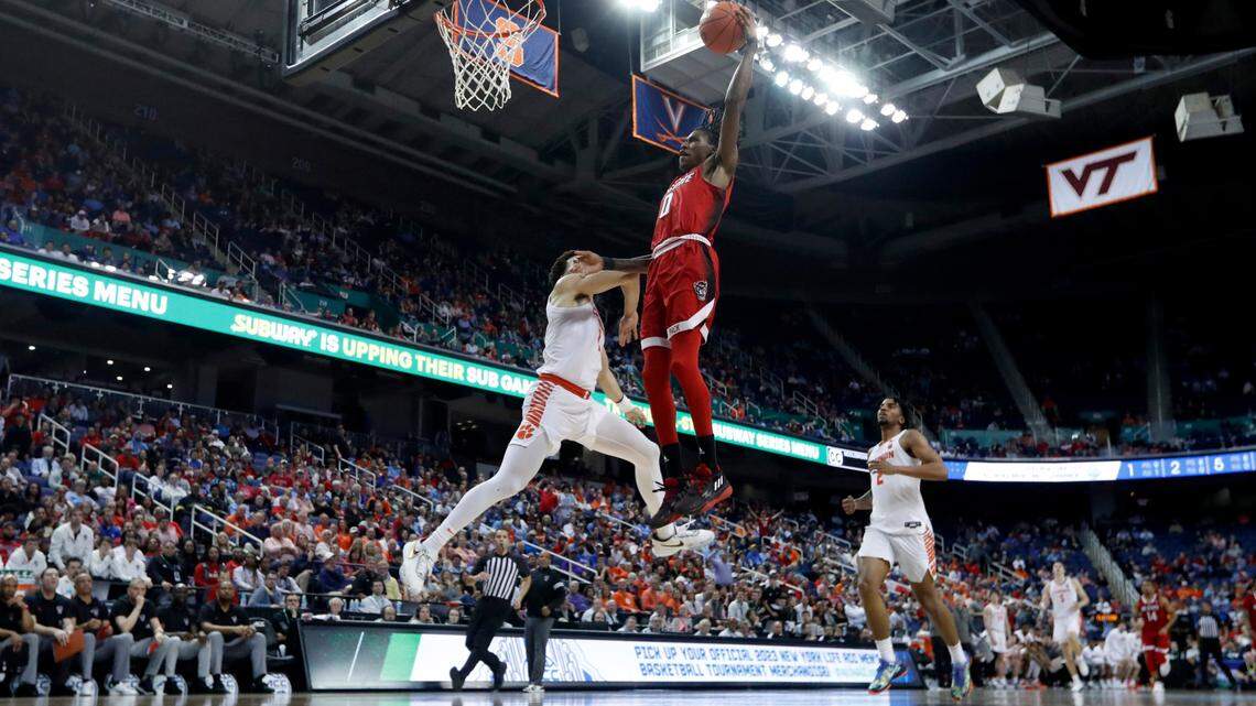 N.C. State’s Terquavion Smith (0) heads to slam in two as Clemson’s Chase Hunter (1) defends during Clemson’s 80-54 victory over N.C. State in the quarterfinals of the ACC Men’s Basketball Tournament in Greensboro, N.C., Thursday, March 9, 2023.