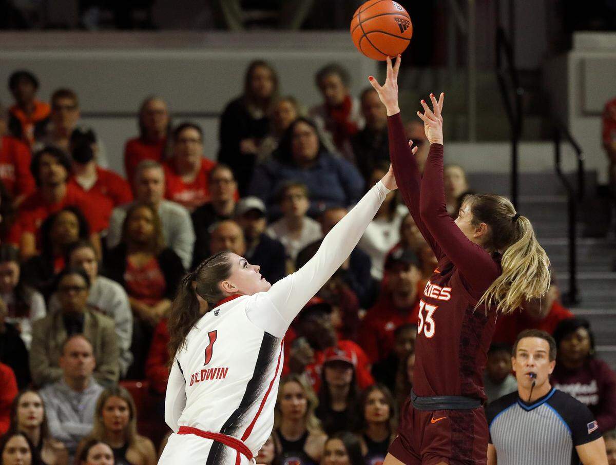 Virginia Tech’s Elizabeth Kitley shoots over N.C. State’s River Baldwin during the first half of the Wolfpack’s game on Thursday, Feb. 8, 2024, at Reynolds Coliseum in Raleigh, N.C.