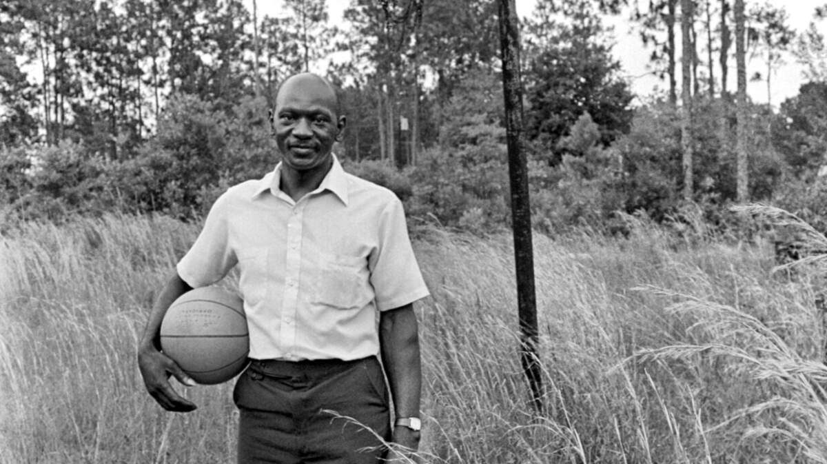 A 1984 photo shows James Jordan, the late father of basketball superstar Michael Jordan, standing by the old basketball goal beside the house where Jordan grew up in Wilmington, N.C.