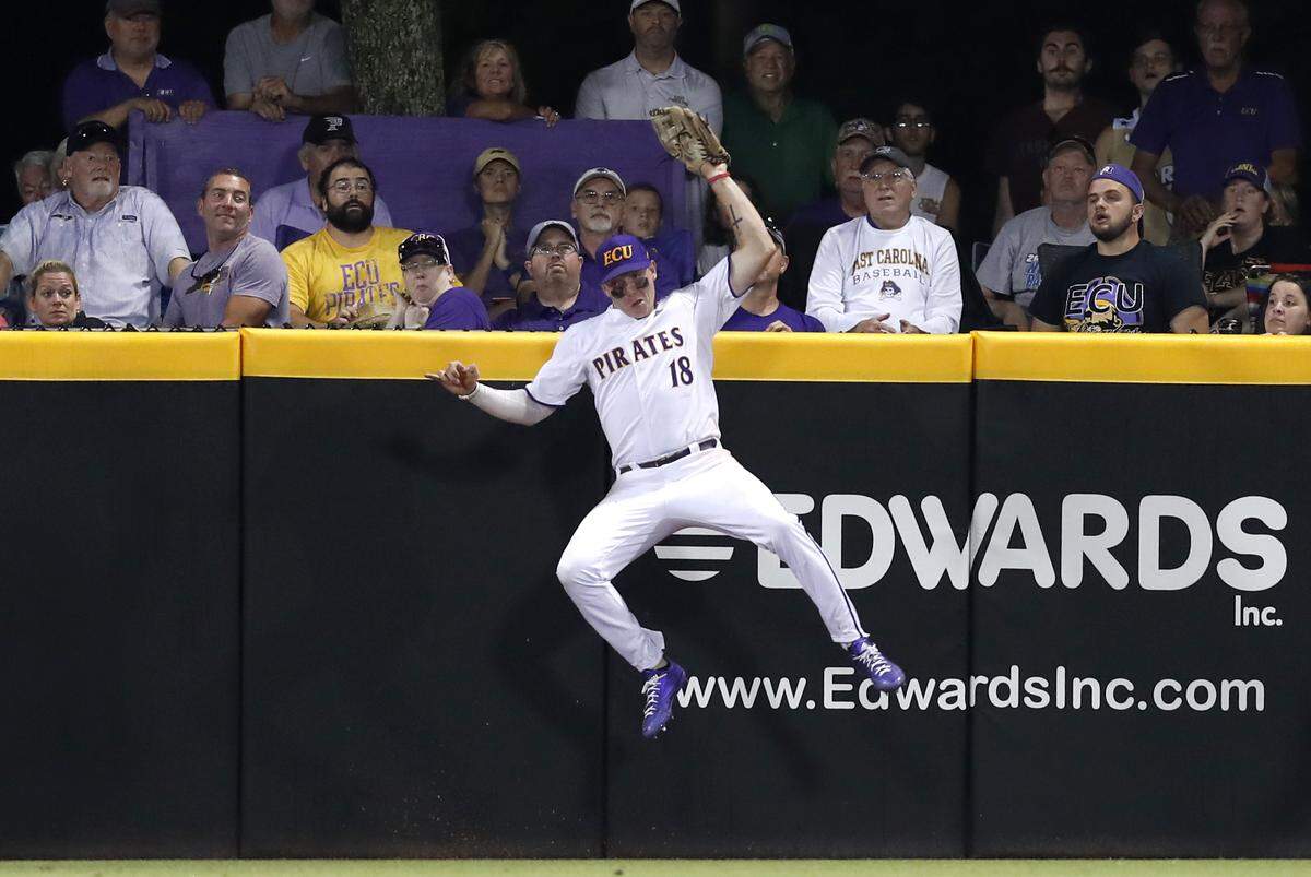 ECU’s Bryant Packard (18) makes the catch against the wall in the ninth inning during Quinnipiac’s 5-4 victory over East Carolina University in the Greenville Regional at Clark-LeClair Stadium in Greenville, N.C., Saturday, June 1, 2019.