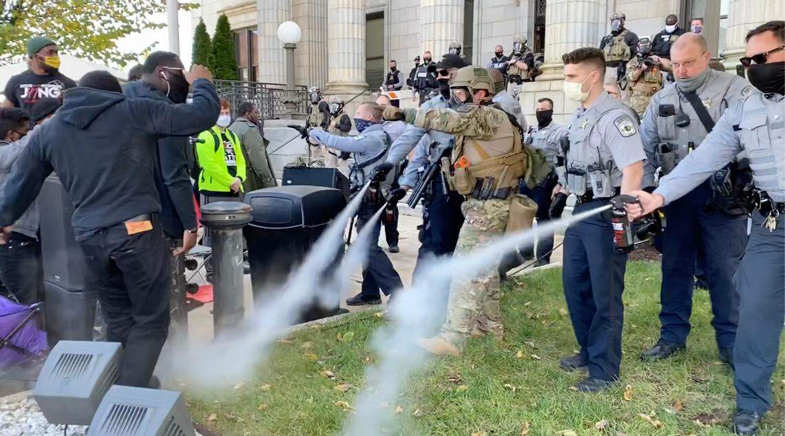 In this image taken from video, Alamance County sheriff’s deputies use pepper spray on a crowd of protesters at the courthouse in Graham, N.C. on Saturday, Oct. 31, 2020.