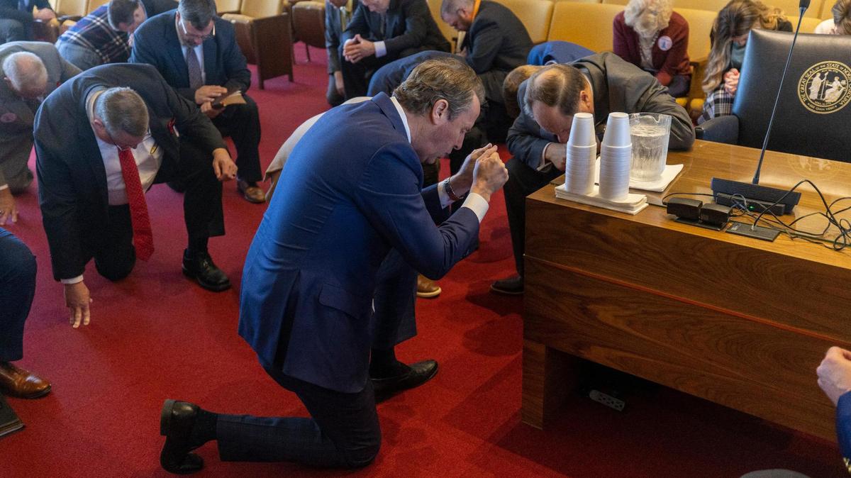Former U.S. Rep. Mark Walker kneels in prayer with a group of clergy from across North Carolina following a meeting with North Carolina lawmakers, calling for a six week abortion ban, on Tuesday, February 28, 2023 at the General Assembly in Raleigh, N.C.