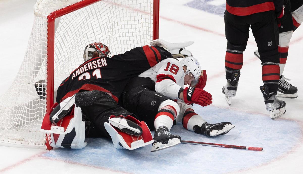 New Jersey left wing Ondrej Palat (18) collides with Carolina Hurricanes goalie Frederik Andersen (31) in the net on a scoring attempt in the second period during game two of their Stanley Cup playoff series on Tuesday, April 22, 2025 at Lenovo Center in Raleigh, N.C.