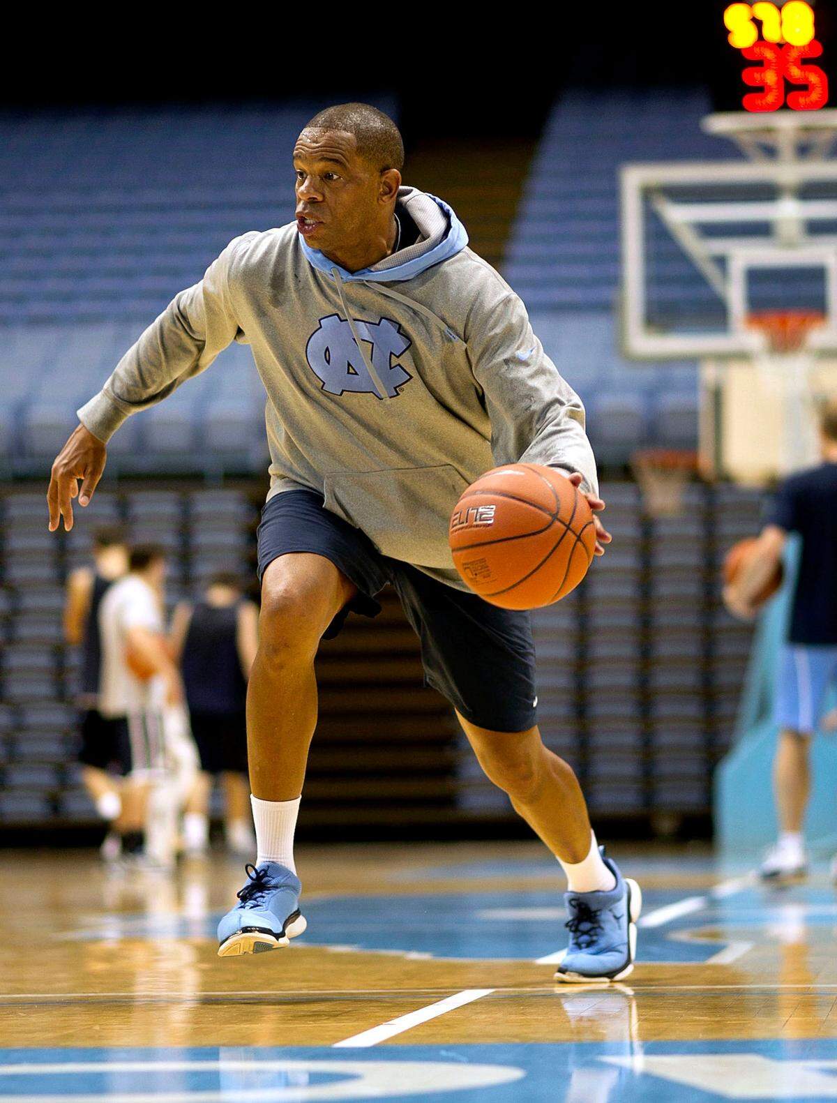UNC JV coach Hubert Davis shows his team how to run a play on the first day of practice on October 10, 2013 at the Smith Center in Chapel Hill, N.C.