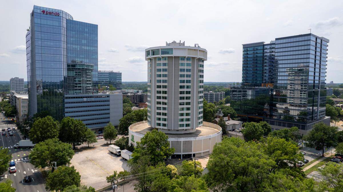 An aerial view of the iconic cylindrical Holiday Inn building in downtown Raleigh on Wednesday, June 4, 2025. Originally slated for demolition, the building’s owners, Tidal Real Estate Partners, confirmed plans to convert the 20-story building at 320 Hillsborough St. into a Hotel Indigo, a brand of IHG Hotels & Resorts.