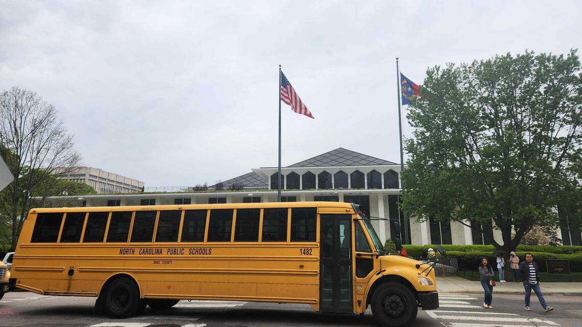A Wake County Public Schools System bus waits outside the N.C. Legislative Building in downtown Raleigh on Tuesday, April 9, 2024. The General Assembly’s expansion of the Opportunity Scholarships program, which gives taxpayer funded vouchers to private schools, may receive additional funding this year to meet demand.