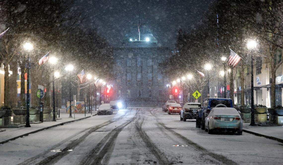 Snow falls on a quiet Fayetteville St. in downtown Raleigh, N.C., Tuesday evening, Jan. 21, 2025.