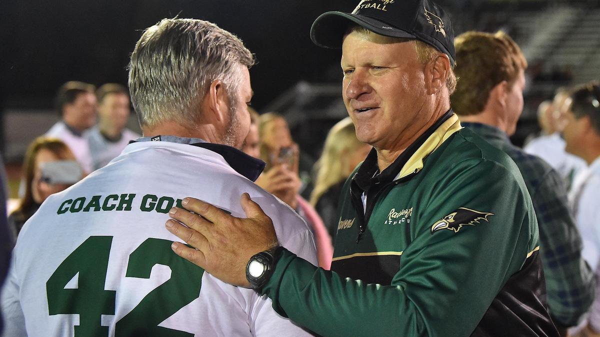 Ravenscroft football head coach Ned Gonet is congratulated by one of his former players at halftime of Gonet’s last game for Ravenscroft. The Ravenscroft Ravens and the Harrells Christian Crusaders met in a football game in Raleigh, N.C. on October 21, 2022.