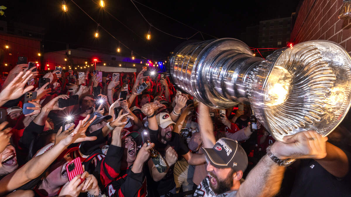 Carolina Hurricanes fans celebrate the team's Stanley Cup Final victory at Teets in Raleigh's Glenwood South district as the Stanley Cup, accompanied by Hurricanes players and staff, makes an appearance during a victory celebration Monday, June 15, 2026. The Hurricanes defeated the Vegas Golden Knights 4-2 in the Stanley Cup Final to win the franchise's second championship since 2006.