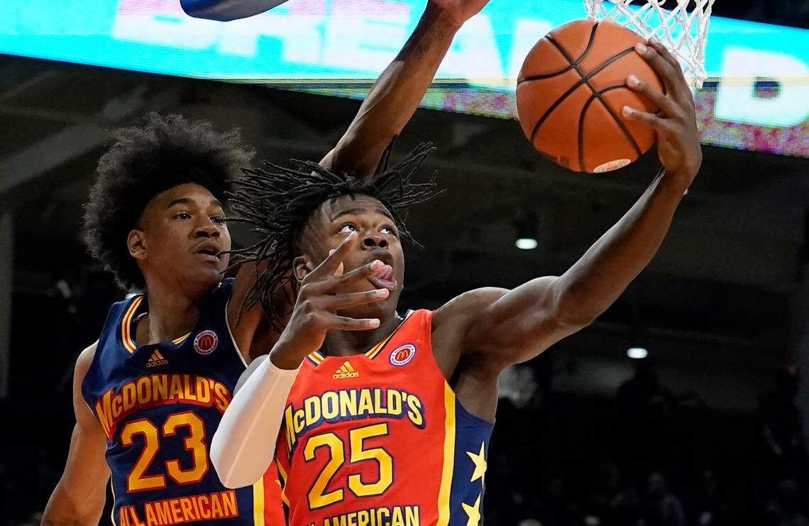 West boy’s Mark Mitchell (25) drives to the basket as East boy’s Dillon Mitchell (23) defends during the McDonald’s All-American Boys basketball game Tuesday, March 29, 2022, in Chicago.