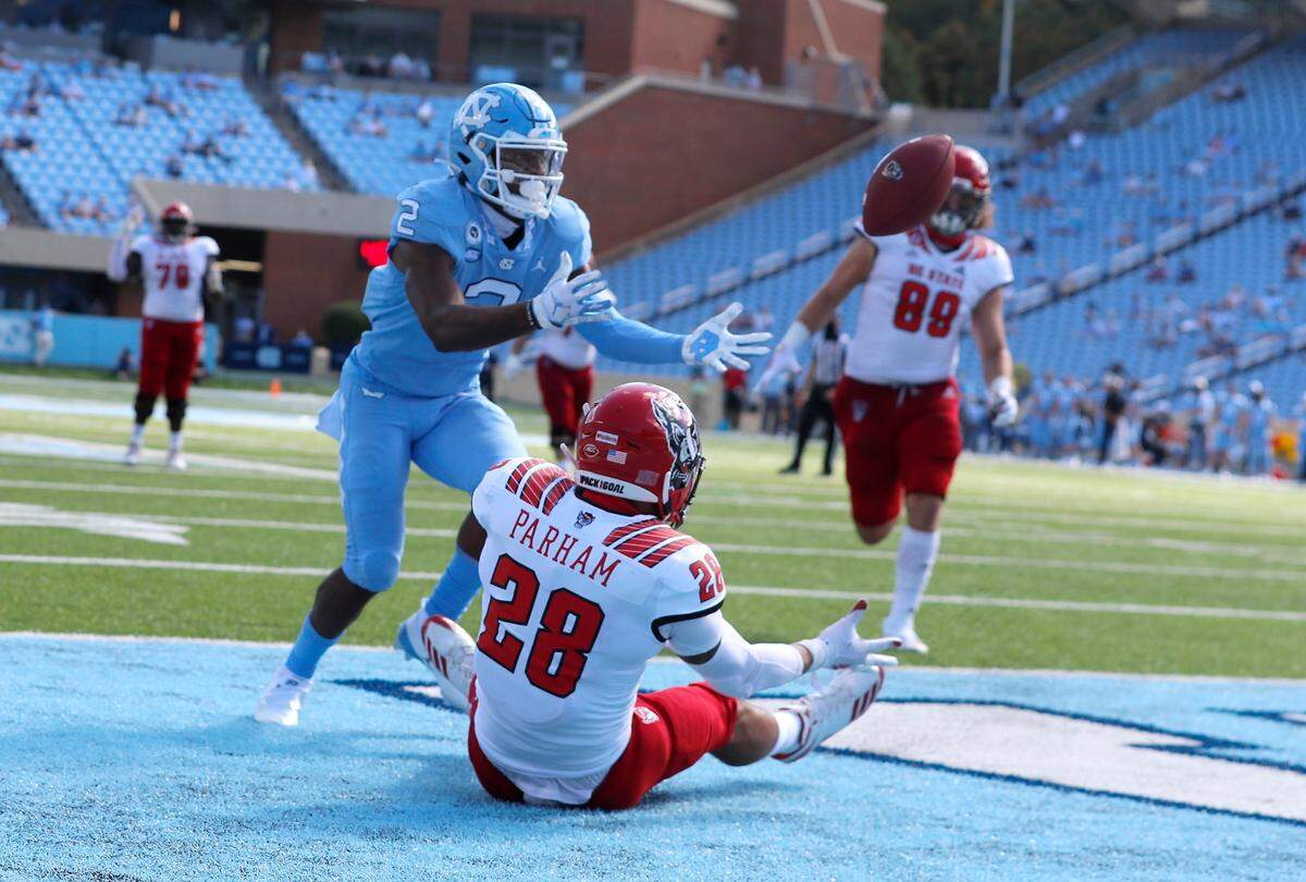 North Carolina defensive back Don Chapman (2) comes in to intercept the ball intended for N.C. State tight end Dylan Parham (28) during the first half of N.C. State’s game against UNC at Kenan Stadium in Chapel Hill, N.C., Saturday, Oct. 24, 2020.