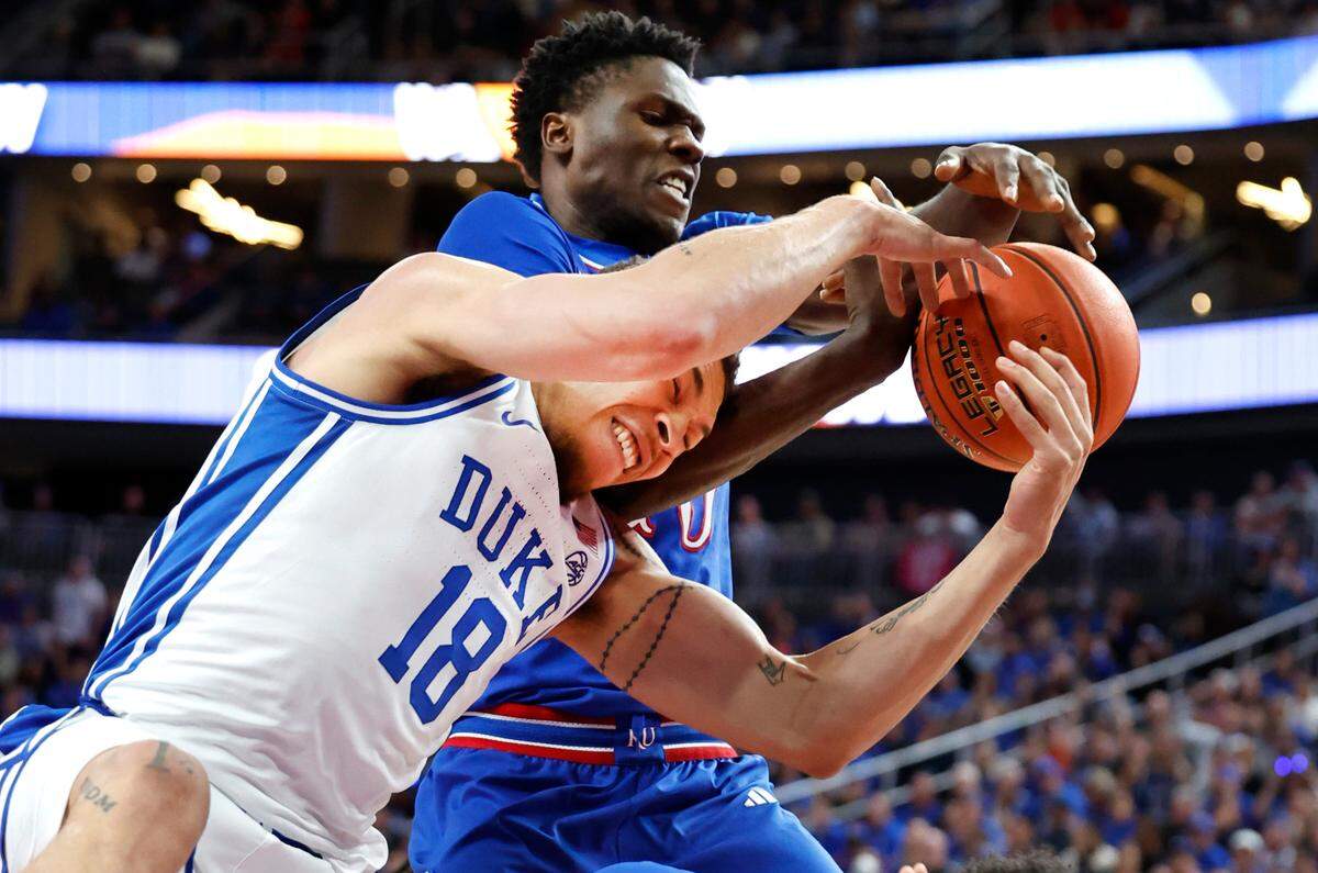 Kansas’ Flory Bidunga (40) pulls the rebound from Duke’s Mason Gillis (18) during the first half of Duke’s game against Kansas in the Vegas Showdown at T-Mobile Arena in Las Vegas, Nev., Tuesday, Nov. 26, 2024.