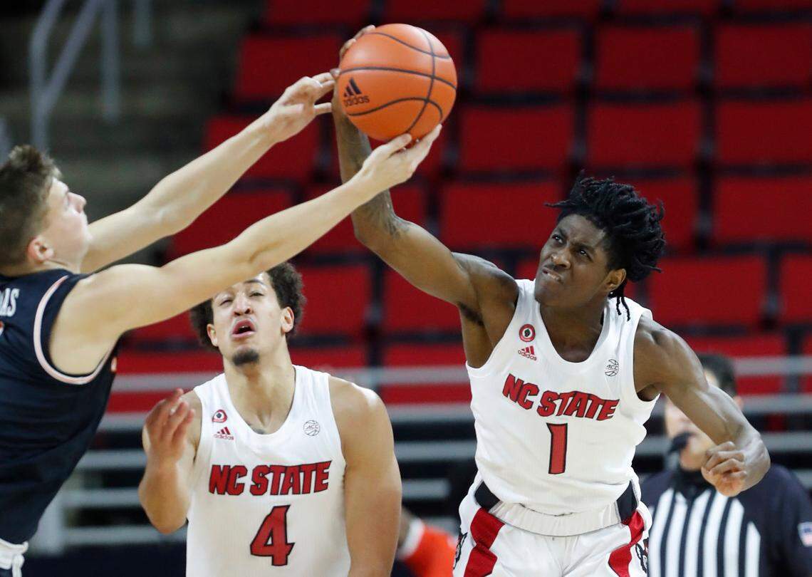 N.C. State’s Dereon Seabron (1) pulls in the rebound as Campbell’s Gediminas Mokseckas (0) comes in during the second half of N.C. State’s 69-50 victory over Campbell at PNC Arena in Raleigh, N.C., Saturday, Dec. 19, 2020.