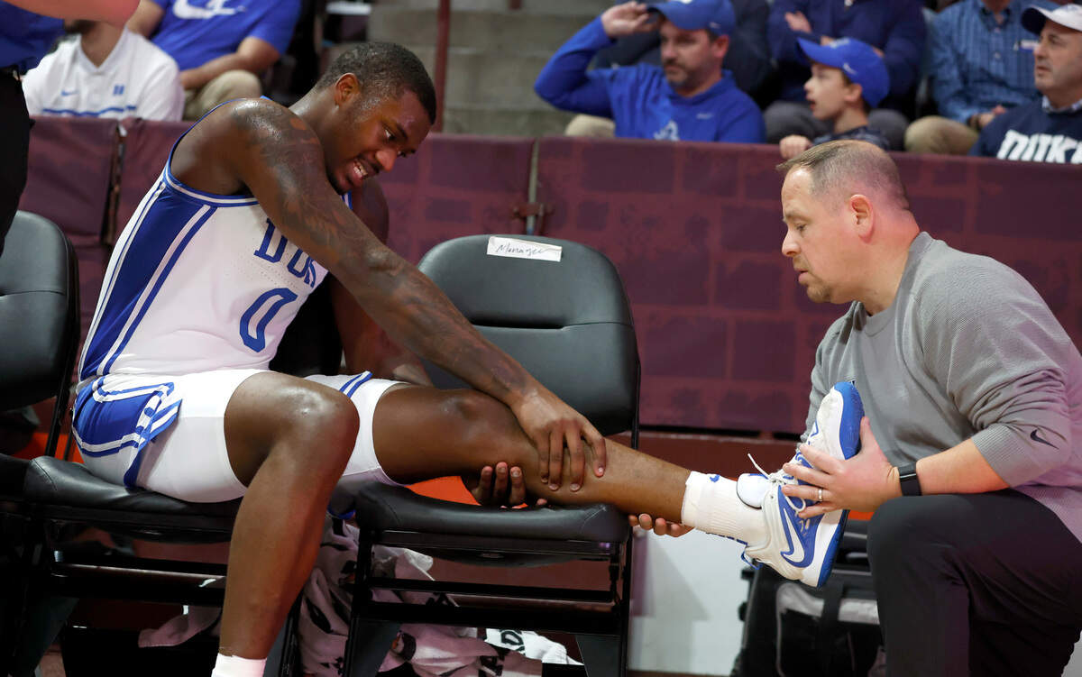 Duke trainer Jose Fonseca checks on the injury to Dariq Whitehead during the second half of Virginia Tech’s 78-75 victory over Duke at Cassell Coliseum in Blacksburg, VA., Monday, Jan. 23, 2023. Whitehead would be helped to the locker room a little bit later.