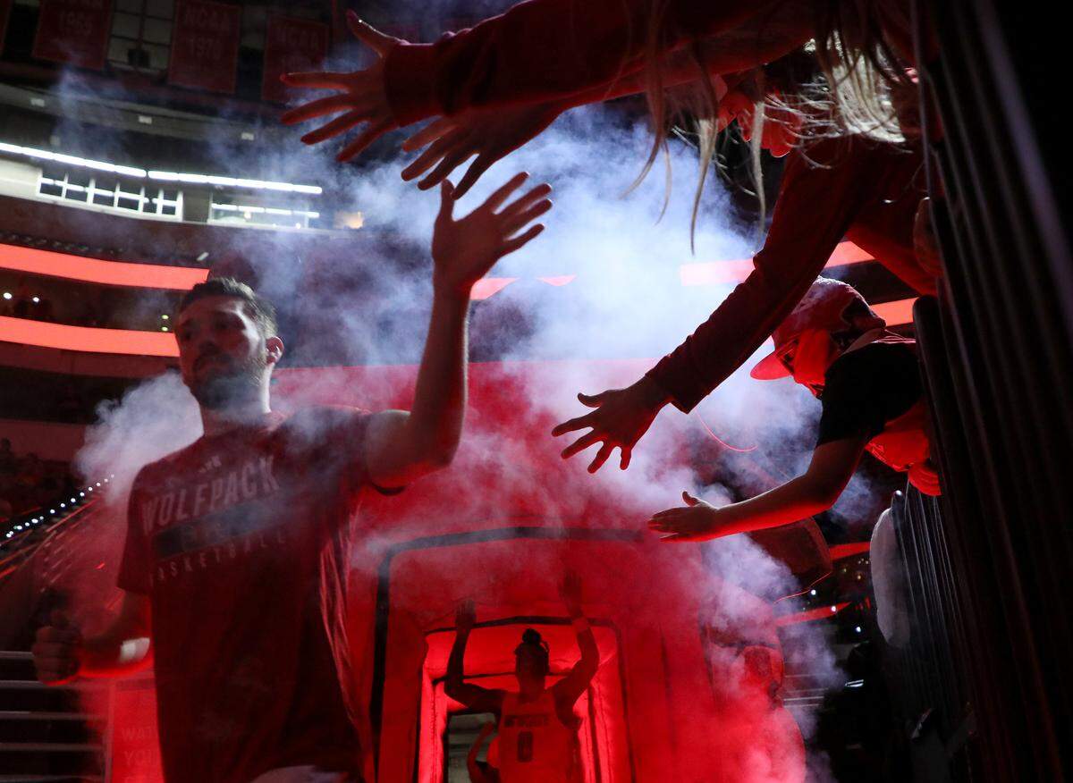 Fans greet the N.C. State men’s basketball team as they take the floor prior to their season-opening game against The Citadel on Monday, Nov. 6, 2023, at PNC Arena in Raleigh, N.C.