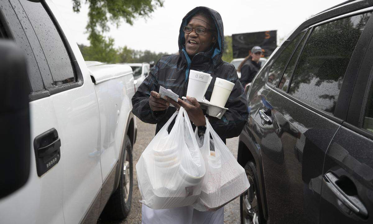 Diane Pittman delivers lunch orders to a customer at Angie's Restaurant.