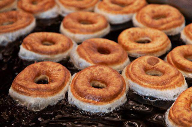 Donuts turn a golden brown on Friday, March 18, 2022, at the new Raleigh bakery, Bright Spot Donuts, which will open soon near the Five Points Neighborhood.