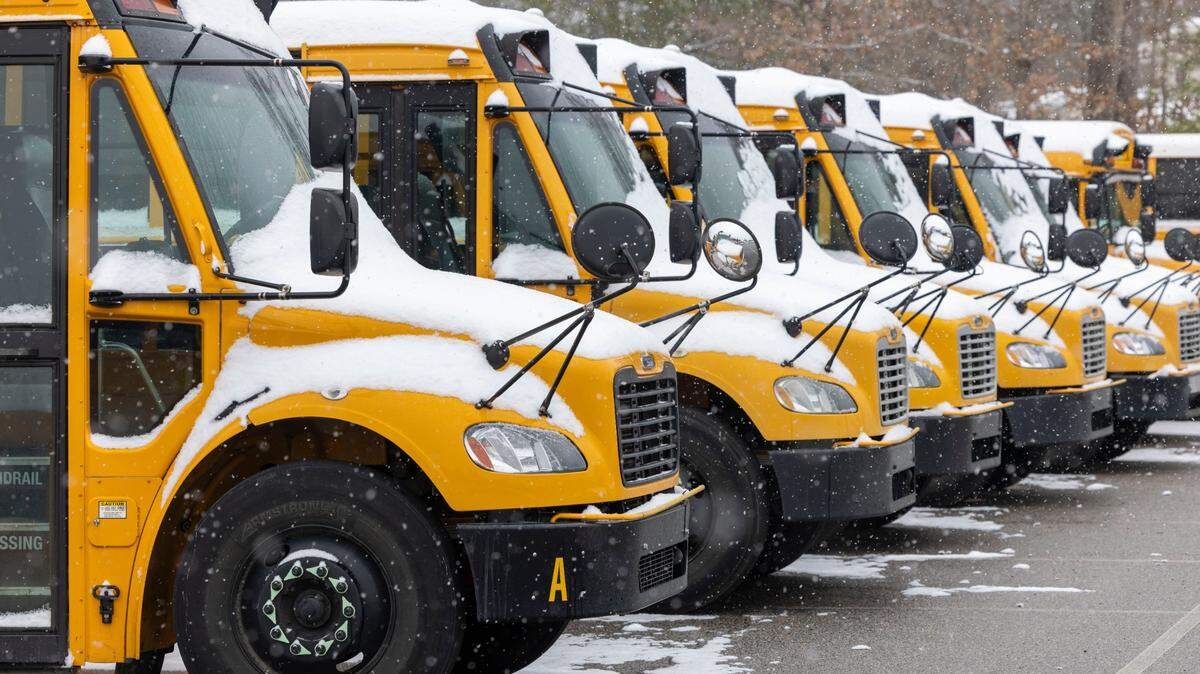 Snow covered buses at Southeast Raleigh Magnet High School, after a winter storm moved through North Carolina on Thursday afternoon February 20, 2025 in Raleigh, N.C. Wake County didn’t use remote learning days during the storm so students will now have to make up the snow days.