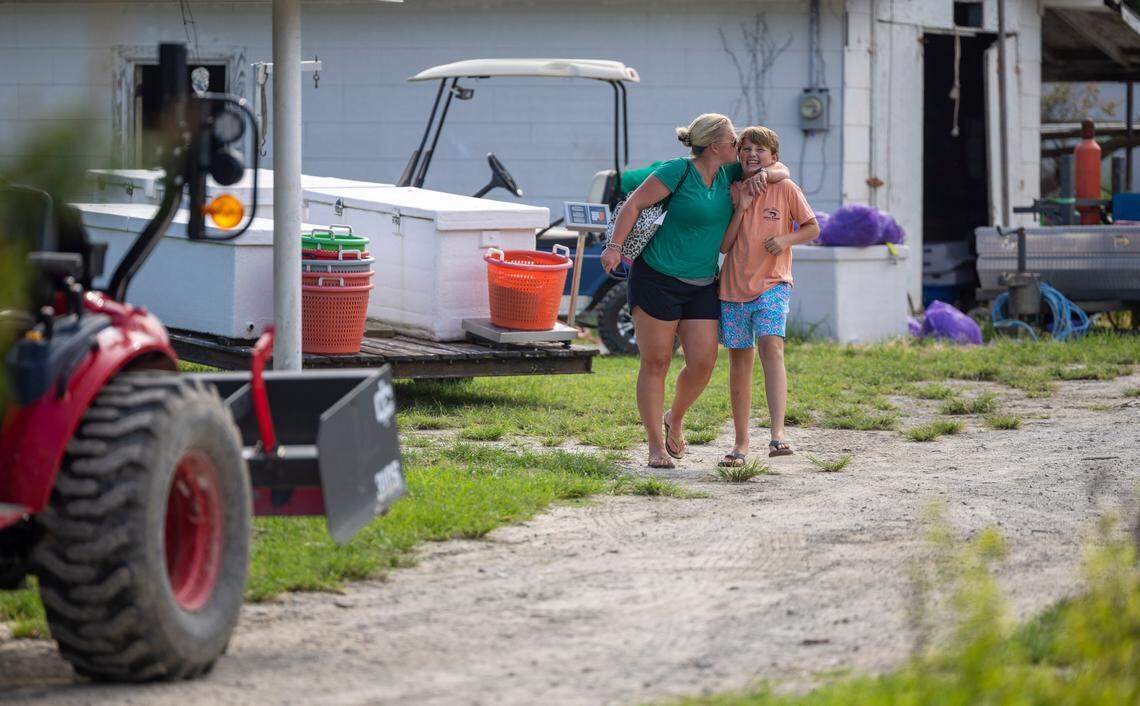 Monica Smith gives her 12-year-old son, Cameron, a kiss. Earlier that day, he returned from a dayslong shrimping trip with his father, Thomas Smith.