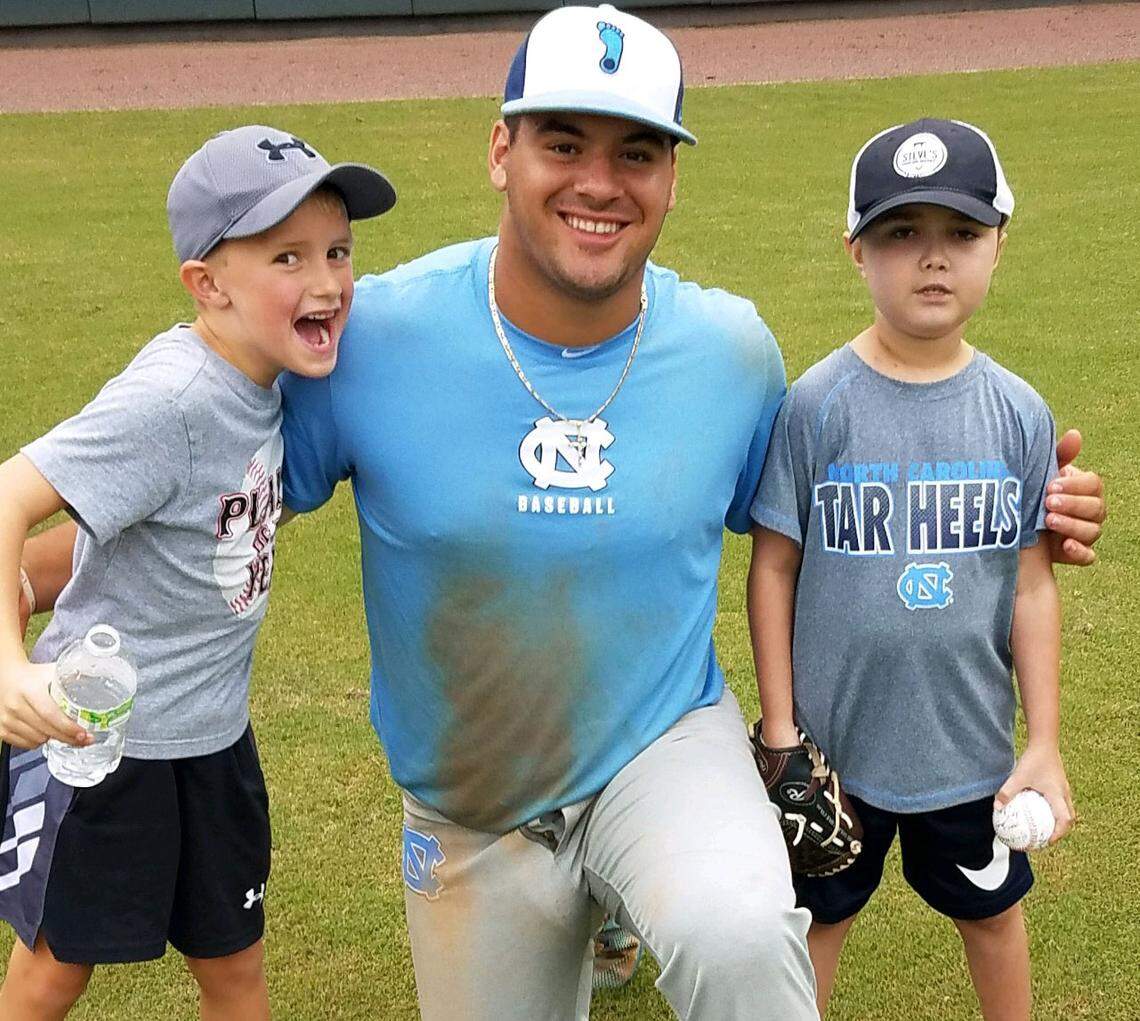 Logan Niles, left and Brady Niles, right, pose for a photograph with North Carolina freshman Aaron Sabato in October 2018 at Boshamer Stadium in Chapel Hill. Sabato formed a friendship with Brady and his family when he was a patient at UNC Hospitals. Photo courtesy of Mike Niles