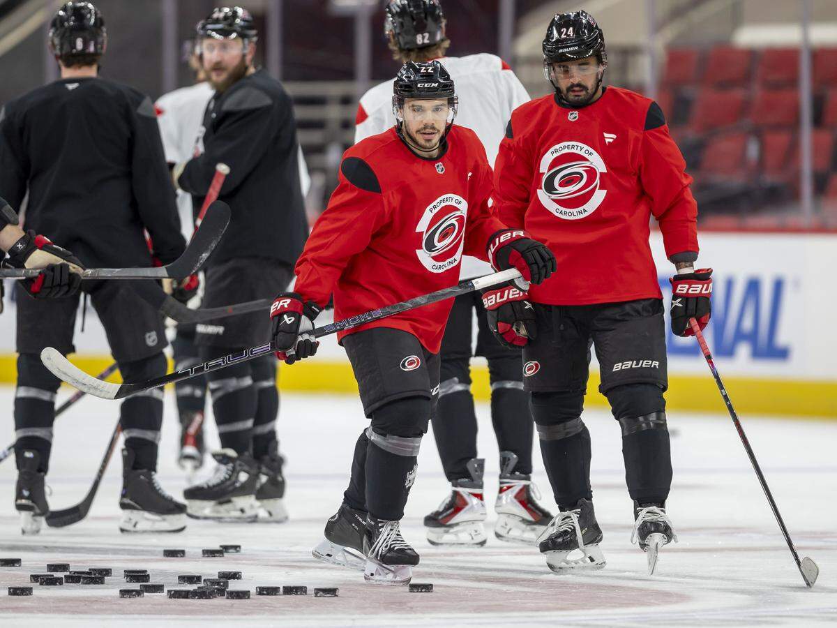 Carolina Hurricanes centers Logan Stankoven (22) and Seth Jarvis (24) take to the ice for their practice on Tuesday, May 12, 2026, at Lenovo Center in Raleigh, N.C.