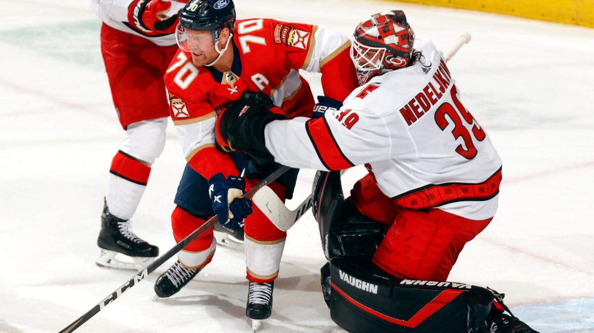 Florida Panthers right wing Patric Hornqvist (70) comes into contact with Carolina Hurricanes goaltender Alex Nedeljkovic (39) during the second period of an NHL hockey game, Saturday, April 24, 2021, in Sunrise, Fla. (AP Photo/Joel Auerbach)