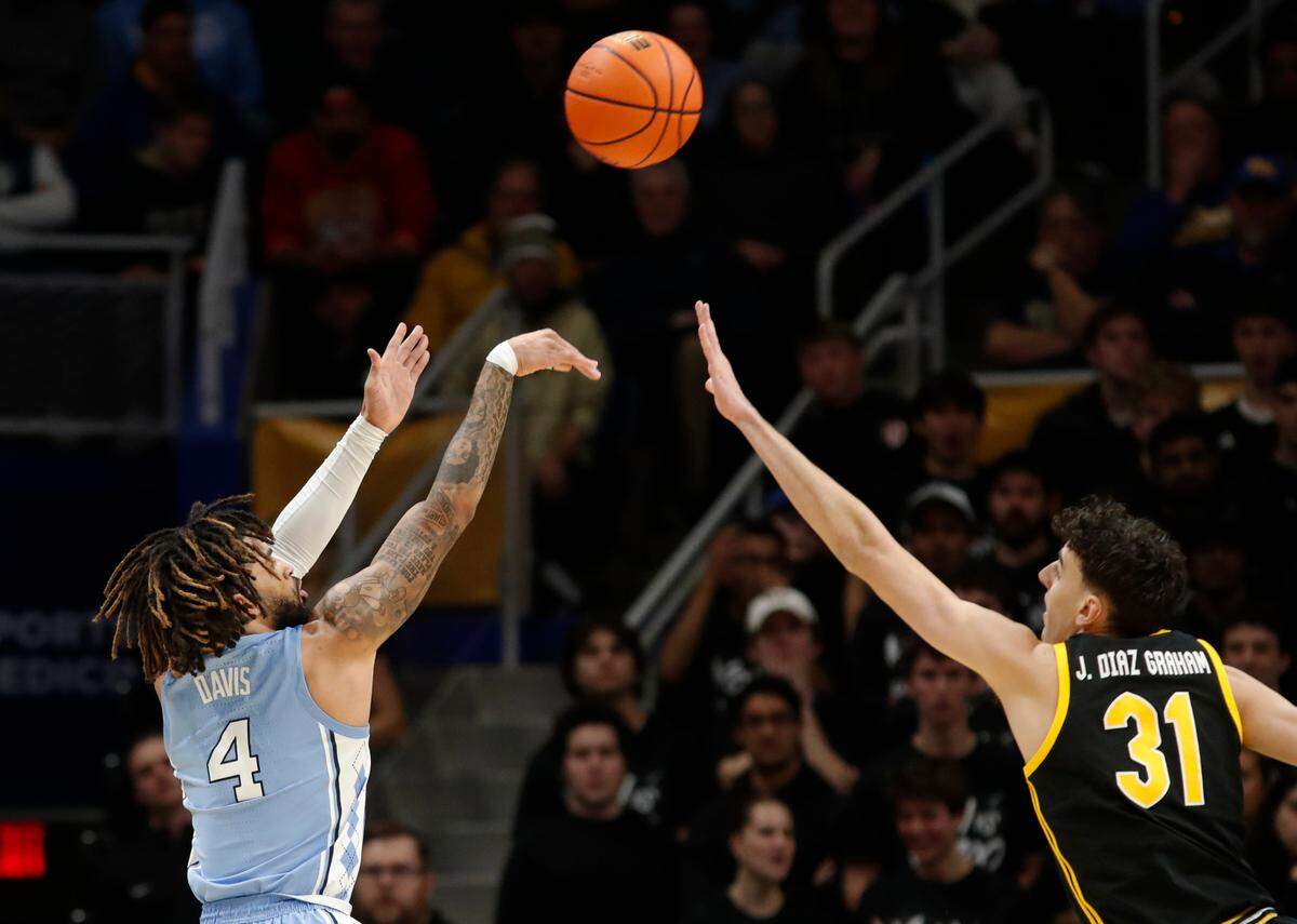 North Carolina Tar Heels guard RJ Davis (4) shoots a three point basket against Pittsburgh Panthers forward Jorge Diaz Graham (31) during the first half at the Petersen Events Center.
