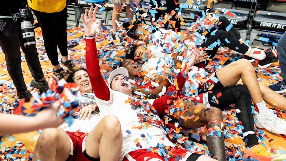 NC State players celebrate in confetti after they defeated Texas, Sunday, March 31, 2024 to earn a spot in the NCAA Women’s Final Four. NC State plays Texas at the Moda Center on March 31, 2024. Jaden Coleman / News & Observer