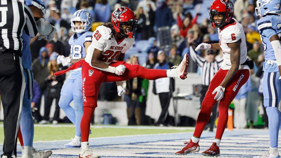 N.C. State running back Hollywood Smothers (20) celebrates scoring on a two-yard touchdown run with 25 seconds left in the game during the Wolfpack’s 35-30 victory over UNC at Kenan Stadium in Chapel Hill, N.C., Saturday, Nov. 30, 2024.