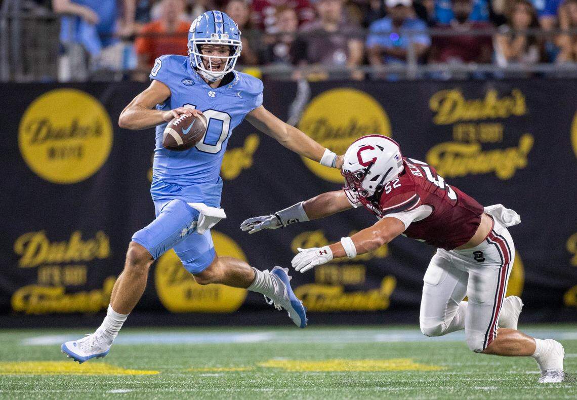 North Carolina quarterback Drake Maye (10) breaks away from South Carolina’s Stone Blanton (52) in the second quarter on Saturday September 2, 2023 at Bank of America Stadium in Charlotte, N.C.