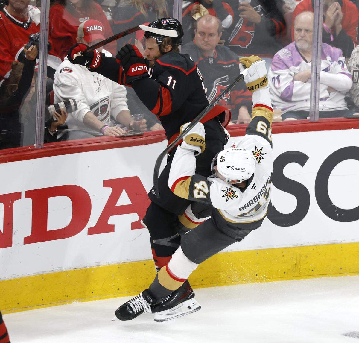 Vegas’ Ivan Barbashev (49) is knocked to the ground as he tries to check Carolina's Jordan Staal (11) in the second period of the Hurricanes’ game against the Golden Knights in the first game of the Stanley Cup Final at the Lenovo Center in Raleigh, N.C., Tuesday, June 2, 2026.