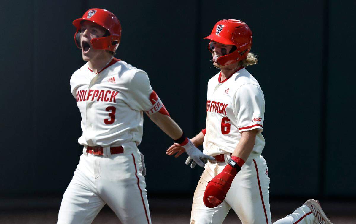 N.C. State’s Brandon Butterworth (3) and Matt Heavner (6) celebrate after Heavner scored on a throwing error to put the Wolfpack up by two in the eighth inning of N.C. State’s 6-4 victory over South Carolina in the NCAA Raleigh Regional at Doak Field Saturday, June 1, 2024.