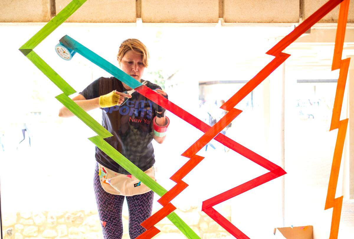 Mary Carter Taub works on her installation "Right Angles" around the facade of House Undergraduate Library on the campus of the University of North Carolina at Chapel Hill.  The art installation is one of many going up around campus for UNC's Arts Everywhere April 6, 2018.