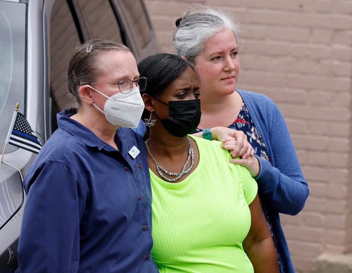 Hayes Barton Pharmacy employees, from left, Peggy Proctor, Giovianni Griffin and Kate Schultz watch as the procession for slain Wake County Sheriffs Deputy Ned Byrd drives down Glenwood Avenue past the Five Points neighborhood in Raleigh, N.C., Friday, August 19, 2022.