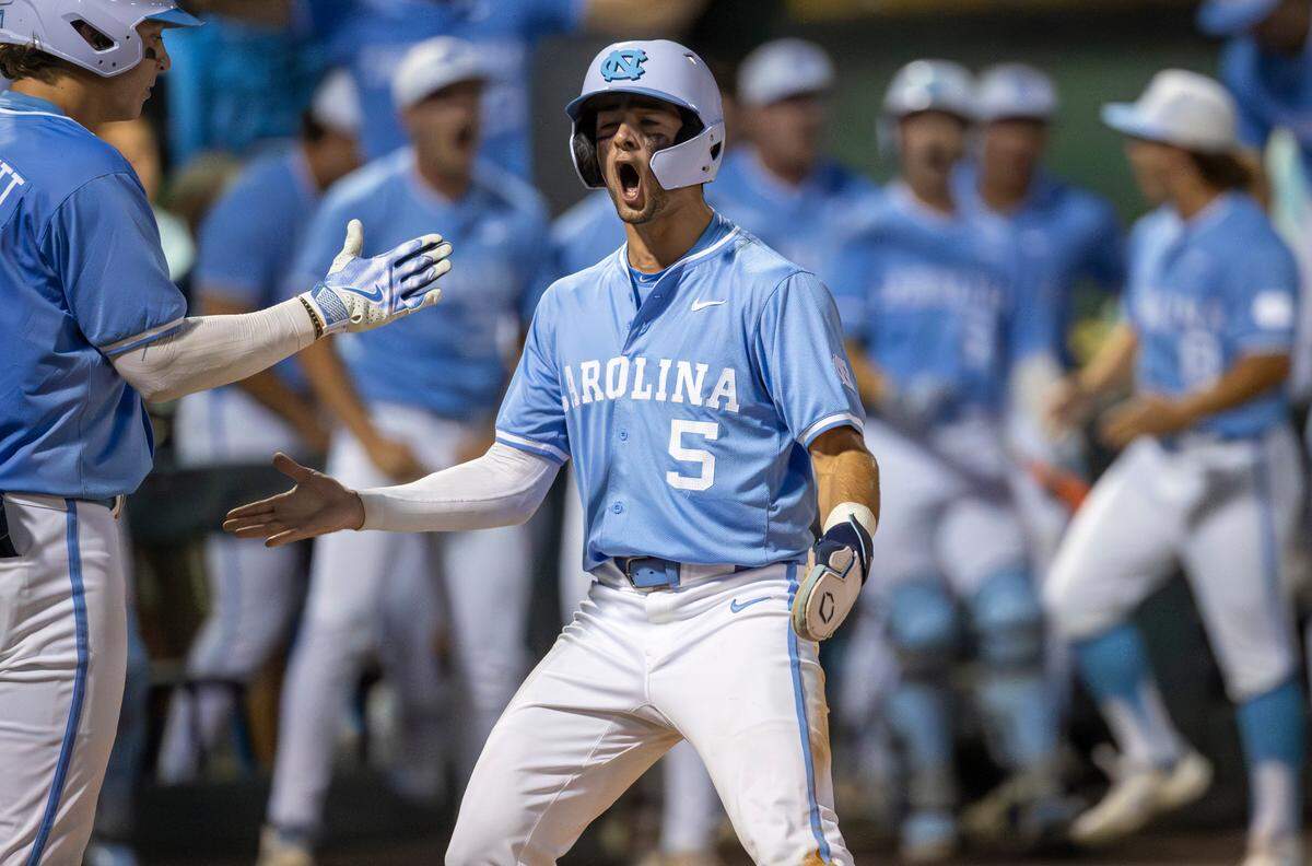 North Carolina third baseman Gavin Gallaher (5) celebrates at home plate with Vance Honeycutt (7) after scoring on a base hit by short stop Colby Wilkerson to tie LSU 3-3 in the ninth inning and force extra innings during the NCAA Regional final on Monday, June 3, 2024 at Boshamer Stadium in Chapel Hill, N.C.