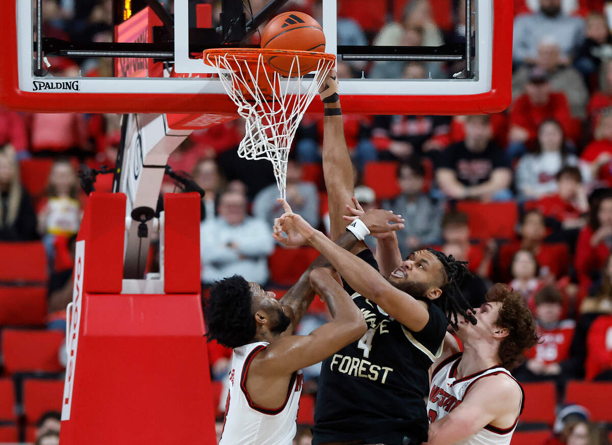 N.C. State’s Dontrez Styles and Ben Middlebrooks pressure Wake Forest’s Efton Reid III at the basket during the first half of the Wolfpack’s game on Saturday, Feb. 22, 2025, at Lenovo Center in Raleigh, N.C.